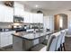 Modern kitchen with white cabinets, granite countertops, and island at 13 Needham Ln, Clayton, NC 27527