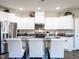 Modern kitchen with white cabinets, granite countertops, and stainless steel appliances at 13 Needham Ln, Clayton, NC 27527