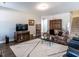 Living room with hardwood floors, fireplace and ample seating at 13 Needham Ln, Clayton, NC 27527