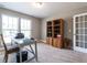Home office featuring a desk, built-in shelving, and French doors at 13 Needham Ln, Clayton, NC 27527