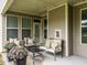 Inviting covered patio featuring comfortable seating, and views of the backyard space at 13 Needham Ln, Clayton, NC 27527