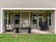 Comfortable covered patio offering outdoor seating, great for enjoying the backyard space with a grill at 13 Needham Ln, Clayton, NC 27527