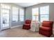 Cozy sitting area with two red chairs and a small table at 13 Needham Ln, Clayton, NC 27527