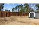 Gray shed with dark gray door in a fenced backyard at 1424 Old Watkins Rd, Raleigh, NC 27616