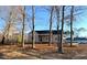 Newly constructed house with gray siding, front porch, and surrounding trees at 170 Squirrel Path Way, Roxboro, NC 27574