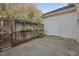 Backyard concrete patio with a privacy fence and storage building at 2031 Rivergate Rd # 105, Raleigh, NC 27614