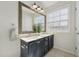 Bathroom featuring double sink vanity with granite countertop, framed mirror, and tile floor at 2031 Rivergate Rd # 105, Raleigh, NC 27614