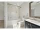 Bright bathroom with white tiling, soaking tub, and vanity at 2031 Rivergate Rd # 105, Raleigh, NC 27614