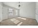 Spacious bedroom with carpeted floors, ceiling fan, and natural light at 2031 Rivergate Rd # 105, Raleigh, NC 27614