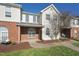 Beautiful exterior of townhome with brick facade, arched windows, and manicured lawn at 2031 Rivergate Rd # 105, Raleigh, NC 27614