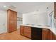 Bright kitchen with wooden cabinets, white countertops, and black appliances at 2031 Rivergate Rd # 105, Raleigh, NC 27614