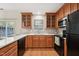 Updated kitchen featuring wooden cabinets, white countertops, black appliances and hardwood floors at 2031 Rivergate Rd # 105, Raleigh, NC 27614