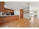 Well-lit kitchen showcases wood cabinetry, a breakfast bar, and flows into living area at 2031 Rivergate Rd # 105, Raleigh, NC 27614