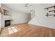 Bright living room featuring hardwood floors, a fireplace, and staircase at 2031 Rivergate Rd # 105, Raleigh, NC 27614