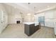 Open concept kitchen with island, white cabinets, and a farmhouse sink at 250 Ellington Rd, Graham, NC 27253