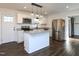 Modern kitchen with island, stainless steel appliances, and white cabinets at 213 Drew St, Louisburg, NC 27549