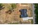 An aerial view showcases a well-maintained home with a dark roof and a spacious surrounding yard at 250 Ellington Rd, Graham, NC 27253