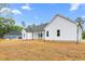 Rear exterior view of a home with white siding and a sprawling backyard at 250 Ellington Rd, Graham, NC 27253