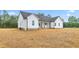 Side and back exterior view of the white home and ample backyard at 250 Ellington Rd, Graham, NC 27253