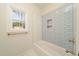 Modern bathroom features tile shower, bathtub, and window view at 250 Ellington Rd, Graham, NC 27253