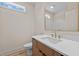 Modern bathroom featuring wood vanity, white countertop, gold faucet, and neutral walls at 250 Ellington Rd, Graham, NC 27253