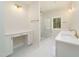 Bright bathroom featuring a glass shower, double vanity, white countertops, and gold hardware at 250 Ellington Rd, Graham, NC 27253