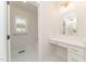Bathroom featuring white vanity with gold hardware, makeup counter and tiled floor at 250 Ellington Rd, Graham, NC 27253