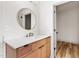 Modern bathroom featuring wooden vanity and gold fixtures at 250 Ellington Rd, Graham, NC 27253