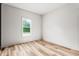 Bedroom featuring wood floors, a window offering natural light, and neutral walls at 250 Ellington Rd, Graham, NC 27253