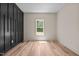 Bedroom featuring dark wood accent wall and bright natural light at 250 Ellington Rd, Graham, NC 27253