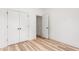 Bright bedroom featuring light wood floors, white walls, and a double door closet at 250 Ellington Rd, Graham, NC 27253