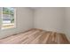 Bright bedroom with light wood flooring and a window with natural light at 250 Ellington Rd, Graham, NC 27253