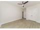 Spacious bedroom with wood-look flooring, closet, neutral walls, and a ceiling fan at 250 Ellington Rd, Graham, NC 27253
