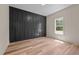 Bedroom featuring custom wood accent wall and light wood flooring at 250 Ellington Rd, Graham, NC 27253
