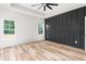 Bedroom with a tray ceiling, fan, and paneled accent wall, creating a cozy and stylish atmosphere at 250 Ellington Rd, Graham, NC 27253