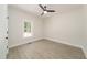 Bright bedroom with wood-look floors, neutral walls, and window view at 250 Ellington Rd, Graham, NC 27253