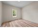 Bright bedroom with hardwood floors and a large window overlooking the backyard at 250 Ellington Rd, Graham, NC 27253