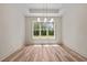 Bright dining room featuring hardwood floors, a modern chandelier, and large windows at 250 Ellington Rd, Graham, NC 27253