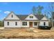 Charming new construction home with white siding, a dark roof, and bright blue sky at 250 Ellington Rd, Graham, NC 27253