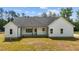 Exterior home elevation with white siding, dark roof and a well-manicured lawn at 250 Ellington Rd, Graham, NC 27253