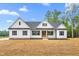 Charming, newly built home with a light-colored exterior, a dark roof, and a inviting front porch at 250 Ellington Rd, Graham, NC 27253