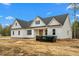 Charming new construction home with white siding, a dark roof, and bright blue sky at 250 Ellington Rd, Graham, NC 27253