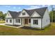 Charming farmhouse with black shutters, gabled roof, and well-maintained lawn at 250 Ellington Rd, Graham, NC 27253