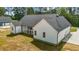 A charming home with white siding, a dark roof, and a well-manicured lawn surrounded by lush greenery at 250 Ellington Rd, Graham, NC 27253