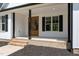 Inviting front porch with brick steps and wooden door at 250 Ellington Rd, Graham, NC 27253