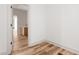 Hallway leads to a vanity with wood cabinets and a brass faucet at 250 Ellington Rd, Graham, NC 27253