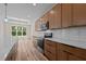 Bright kitchen with wood cabinets, stainless steel appliances, and hardwood floors at 250 Ellington Rd, Graham, NC 27253