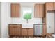 Bright kitchen featuring a farmhouse sink, quartz countertops, and stainless steel dishwasher at 250 Ellington Rd, Graham, NC 27253