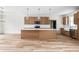 Bright, modern kitchen featuring an island, wood cabinets, and stainless steel appliances at 250 Ellington Rd, Graham, NC 27253