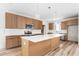 Updated kitchen boasts a center island, wood cabinets, and stainless steel appliances at 250 Ellington Rd, Graham, NC 27253